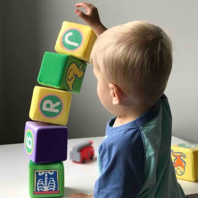 child stacking blocks